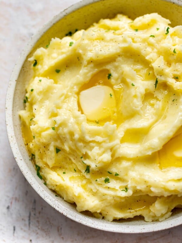 Instant Pot mashed potatoes in a serving bowl with plenty of butter