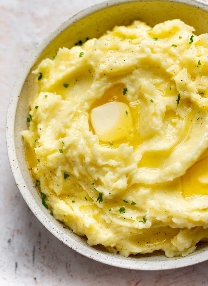 Instant Pot mashed potatoes in a serving bowl with plenty of butter