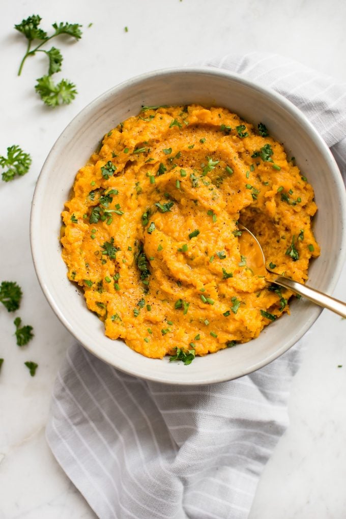 white bowl with Instant Pot mashed sweet potatoes and a spoon