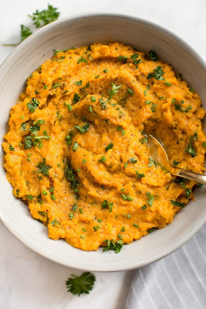 close-up of Instant Pot mashed sweet potatoes in a bowl with a spoon