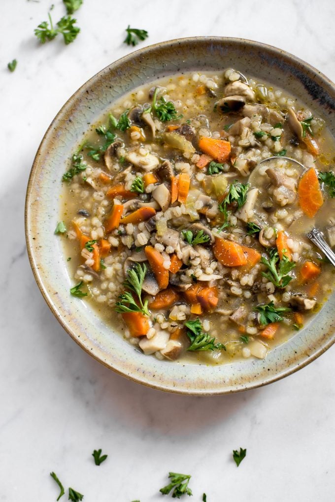 close-up of mushroom barley soup in a stoneware bowl