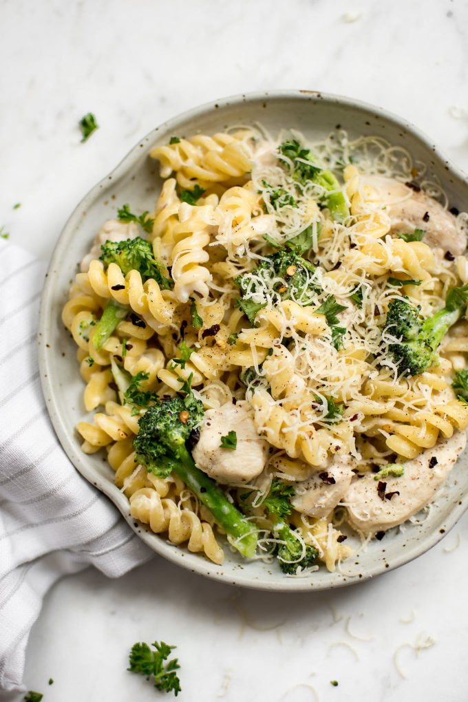 one-pot chicken broccoli pasta on a plate with grated parmesan
