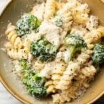 a bowl of chicken and broccoli pasta