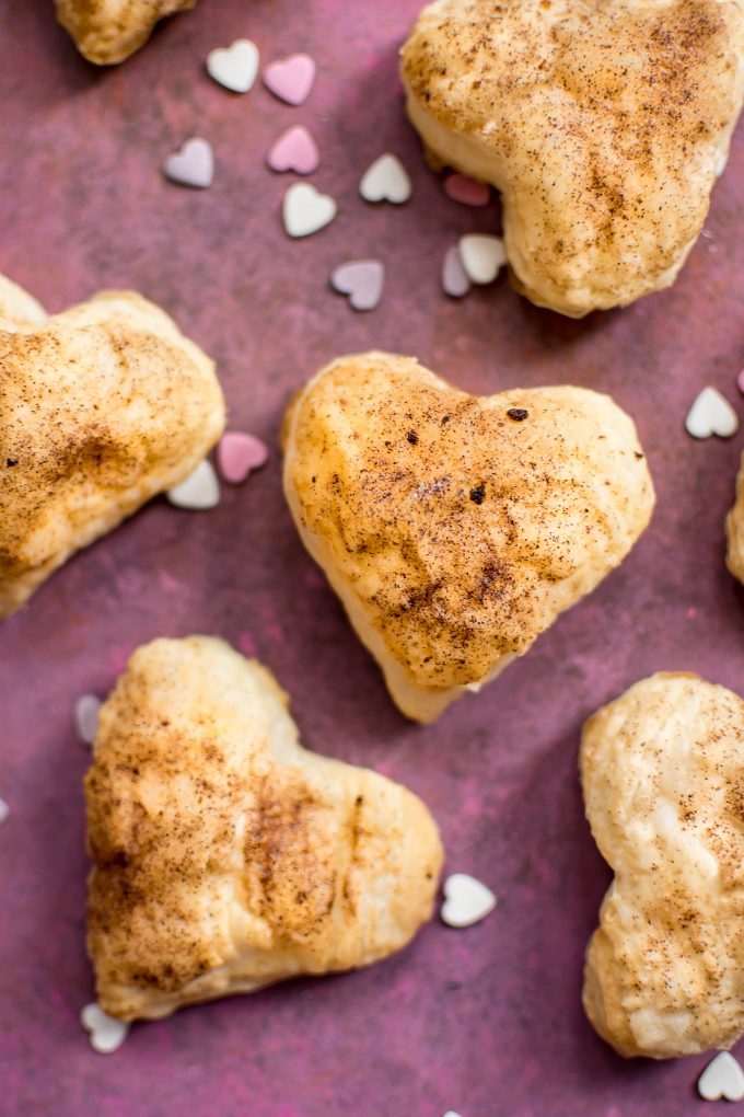 close-up of easy puff pastry hearts with heart sprinkles beside them