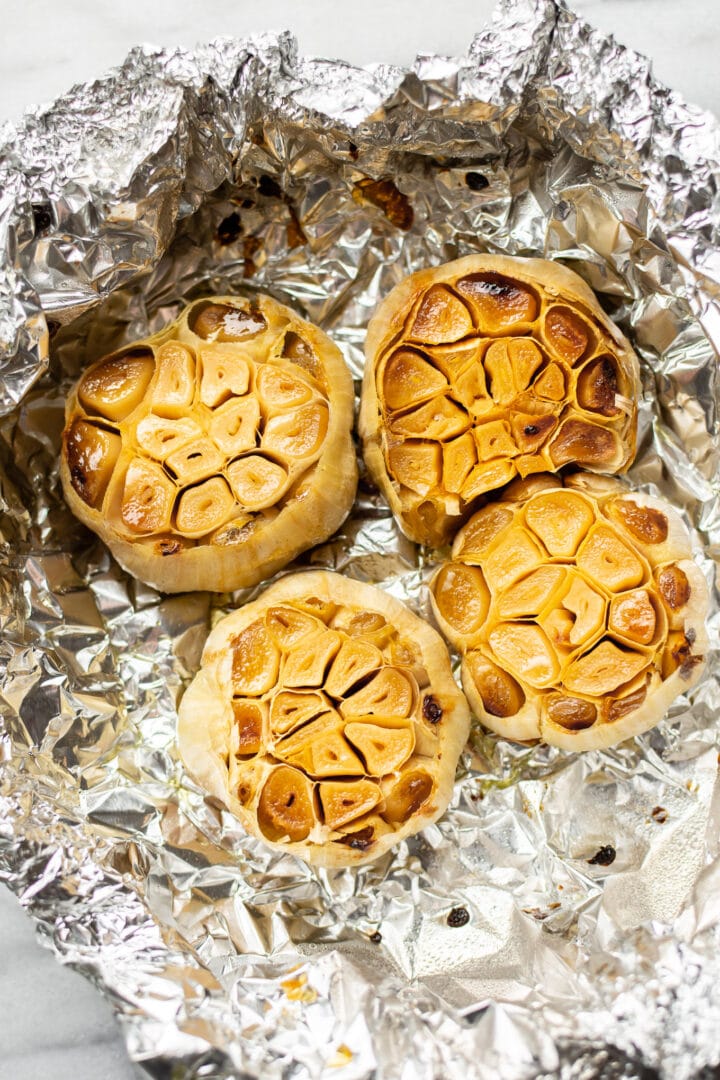 foil with four heads of roasted garlic