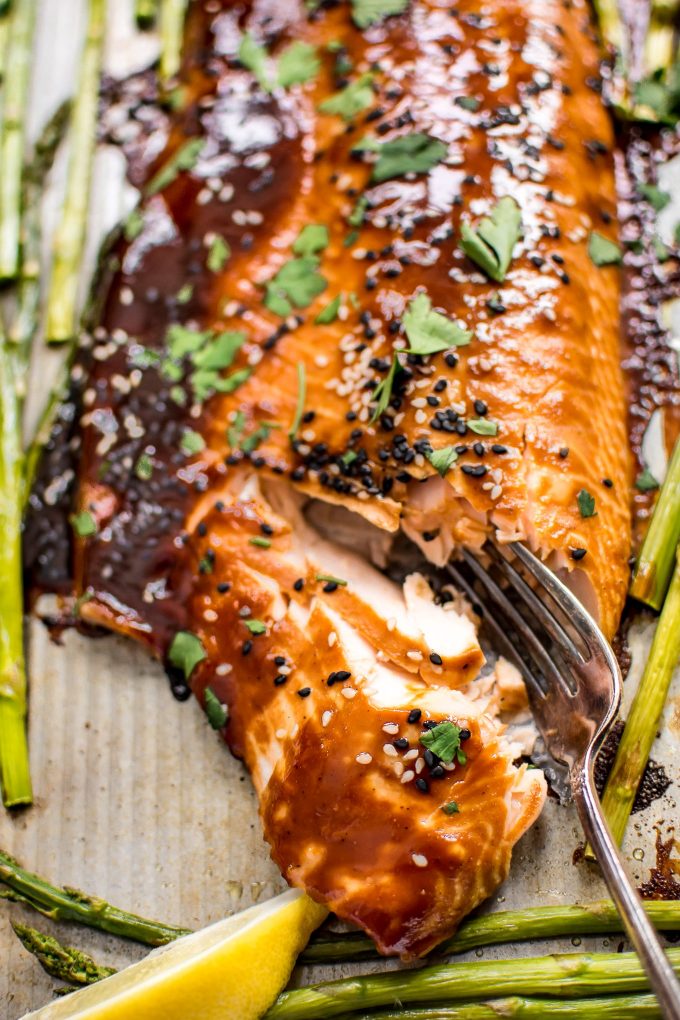 close-up of sheet pan salmon asparagus with a fork