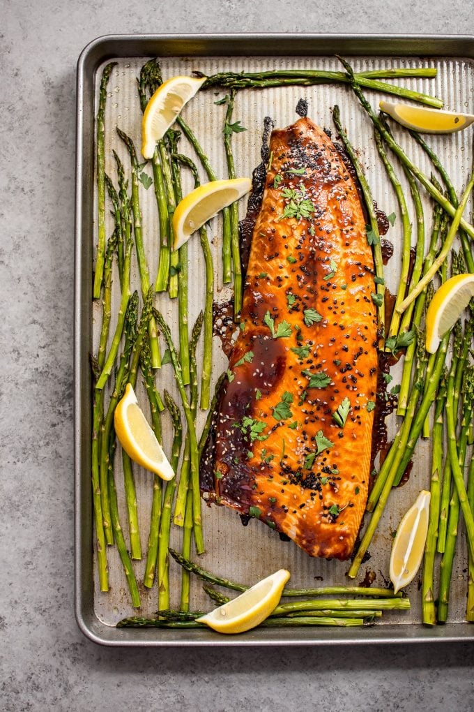 sheet pan with salmon, asparagus, and lemon wedges