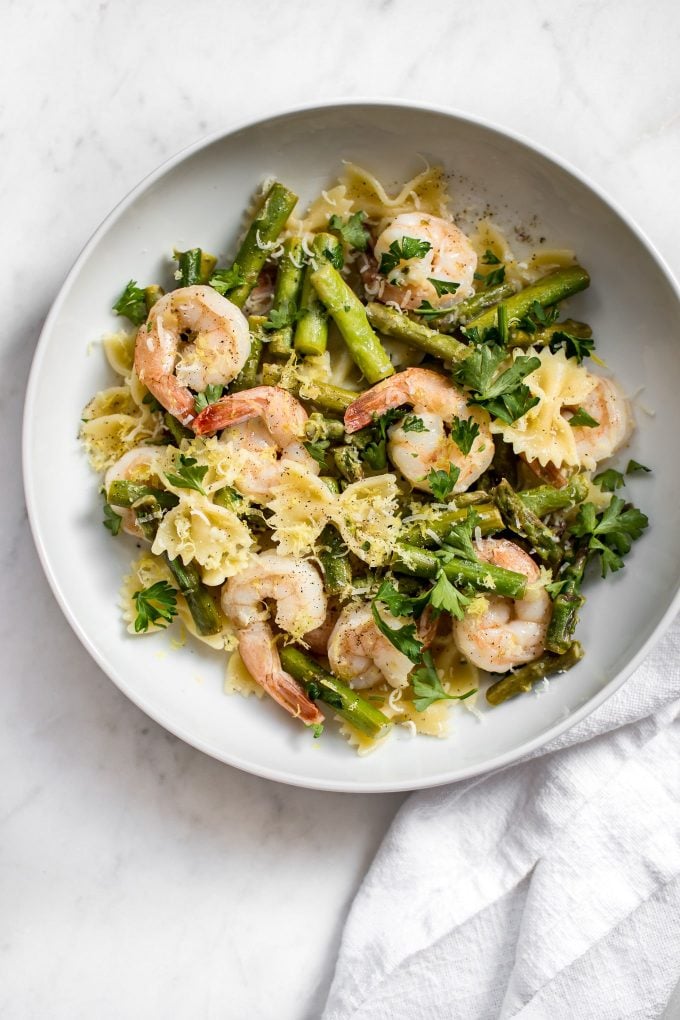 shrimp asparagus pasta on a white plate