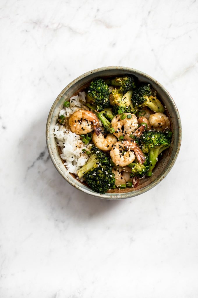 shrimp and broccoli bowl over rice on a marble surface
