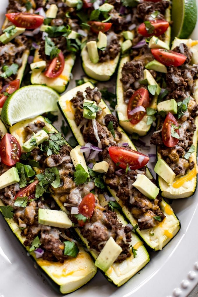 close-up of several low-carb zucchini taco boats with a lime wedge