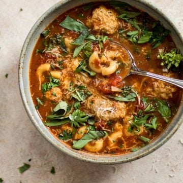 This turkey meatball soup is hearty, filling, and delicious! Tender turkey meatballs, pasta, and fresh herbs in a tomato broth make this one tasty soup.