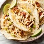 a plate with three blackened shrimp tacos