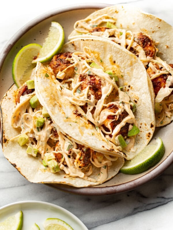 a plate with three blackened shrimp tacos