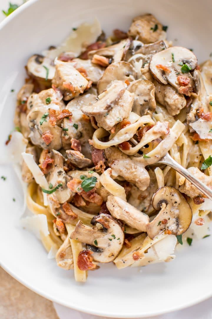 close-up of chicken bacon mushroom pasta on a fork