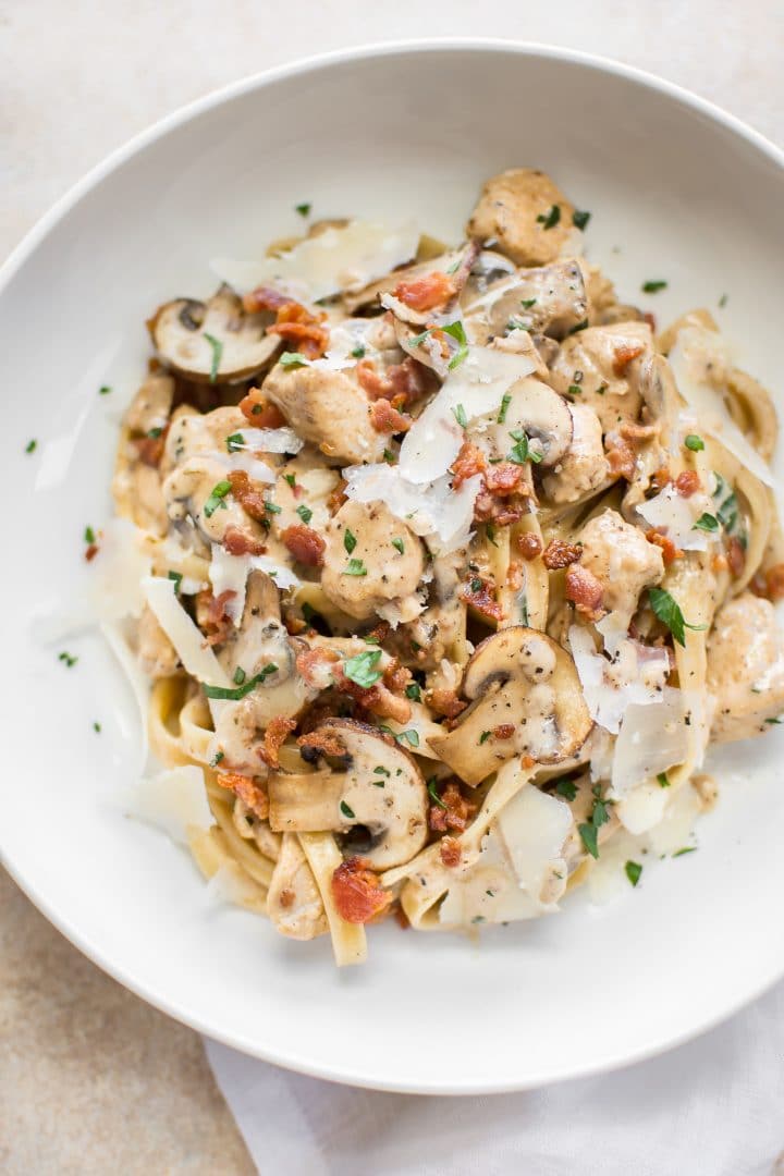 chicken pasta with a creamy balsamic garlic sauce on a plate with grated parmesan