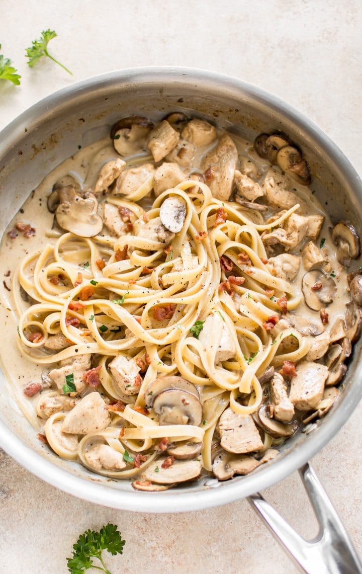 creamy chicken bacon mushroom pasta in a skillet