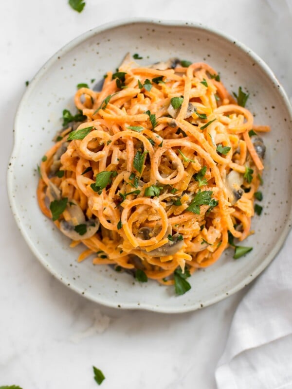 This 20 minute vegetarian creamy mushroom sweet potato noodles recipe is a healthy vegetarian spiralized sweet potato recipe. This recipe will quickly show you how to make sweet potato noodles! The simple garlicky mushroom Alfredo sauce is delicious!