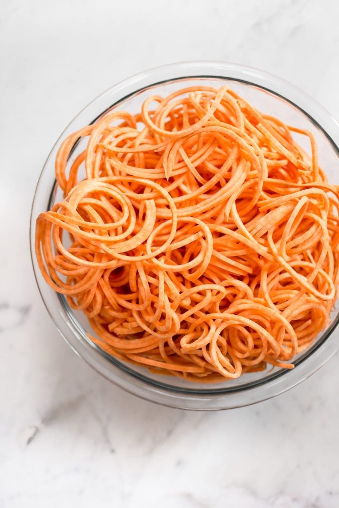 glass bowl with spiralized sweet potatoes