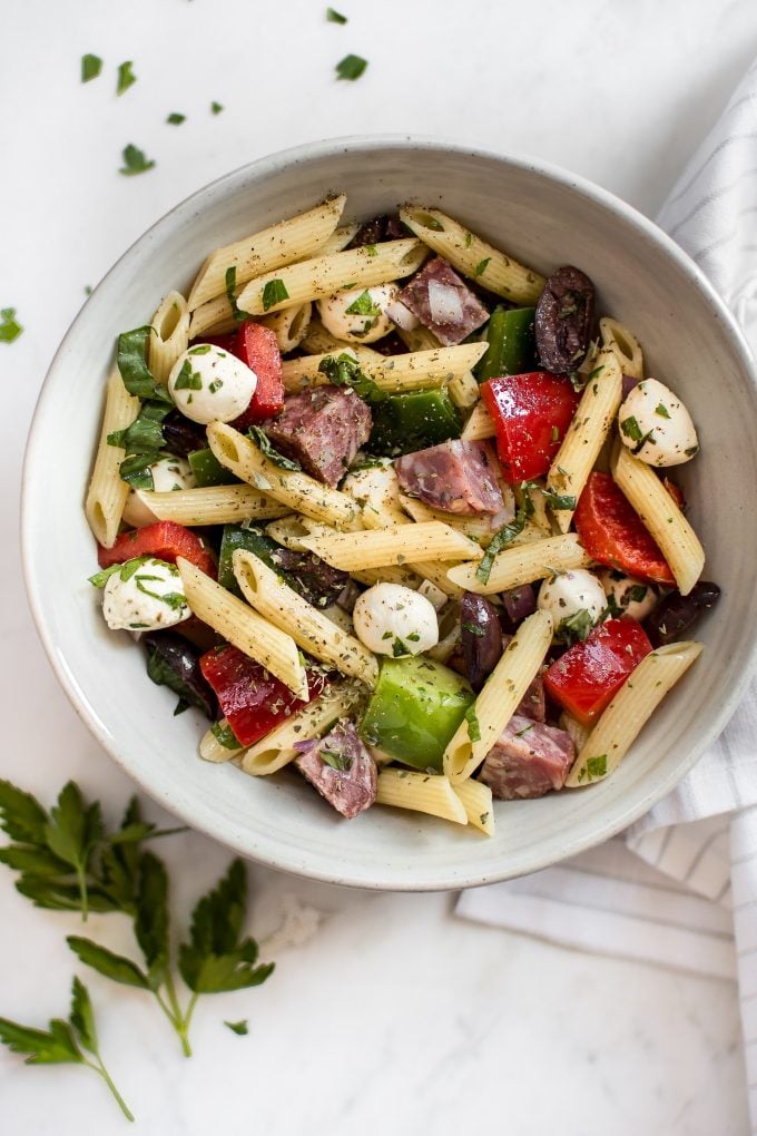 close-up of Italian pasta salad with salami, olives, and peppers in a bowl