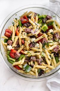 This Italian pasta salad recipe is healthy, fast, and easy to make! It's the best classic cold pasta salad for summer BBQs, picnics, or potlucks. A tangy vinaigrette, salami, mozzarella, and fresh herbs make this one delicious side dish! Feeds a crowd.