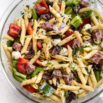 This Italian pasta salad recipe is healthy, fast, and easy to make! It's the best classic cold pasta salad for summer BBQs, picnics, or potlucks. A tangy vinaigrette, salami, mozzarella, and fresh herbs make this one delicious side dish! Feeds a crowd.