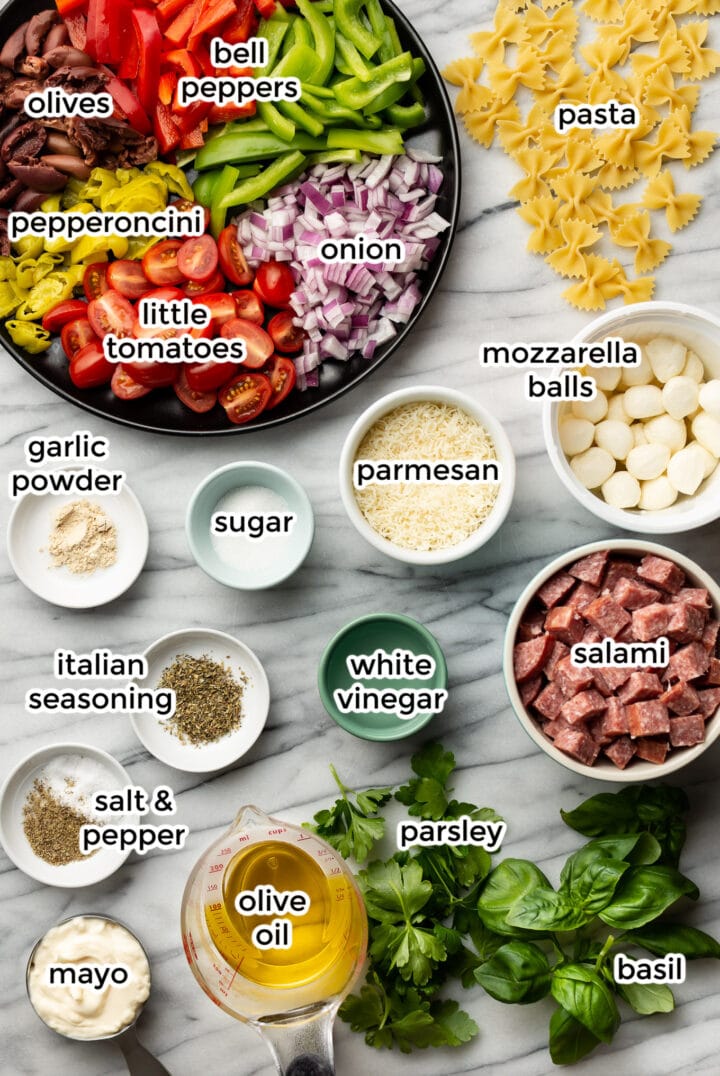 ingredients for italian pasta salad in small bowls on a counter
