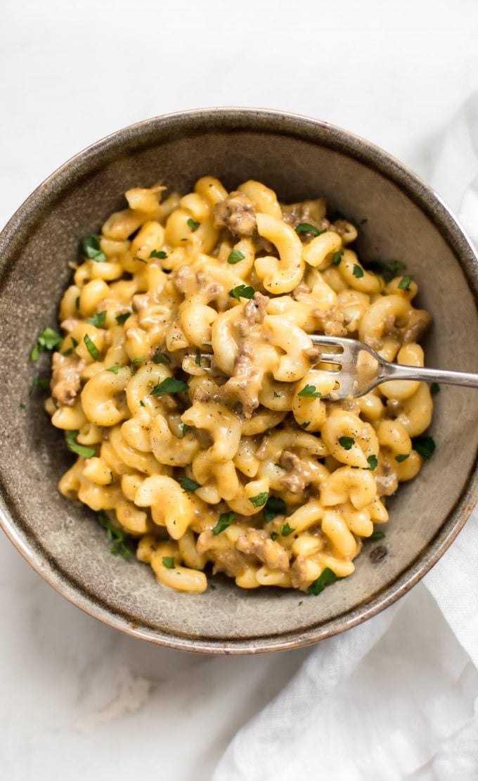 bowl of electric pressure cooker hamburger macaroni and cheese with fork