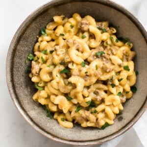 This easy Instant Pot hamburger mac and cheese is total comfort food that's ready in only 30 minutes! No draining of the macaroni is needed, and it's all made right in your electric pressure cooker. This beefy macaroni and cheese is perfect for large families and weeknight meals. You'll love the simple Tex-Mex spice blend that flavors the meat. 