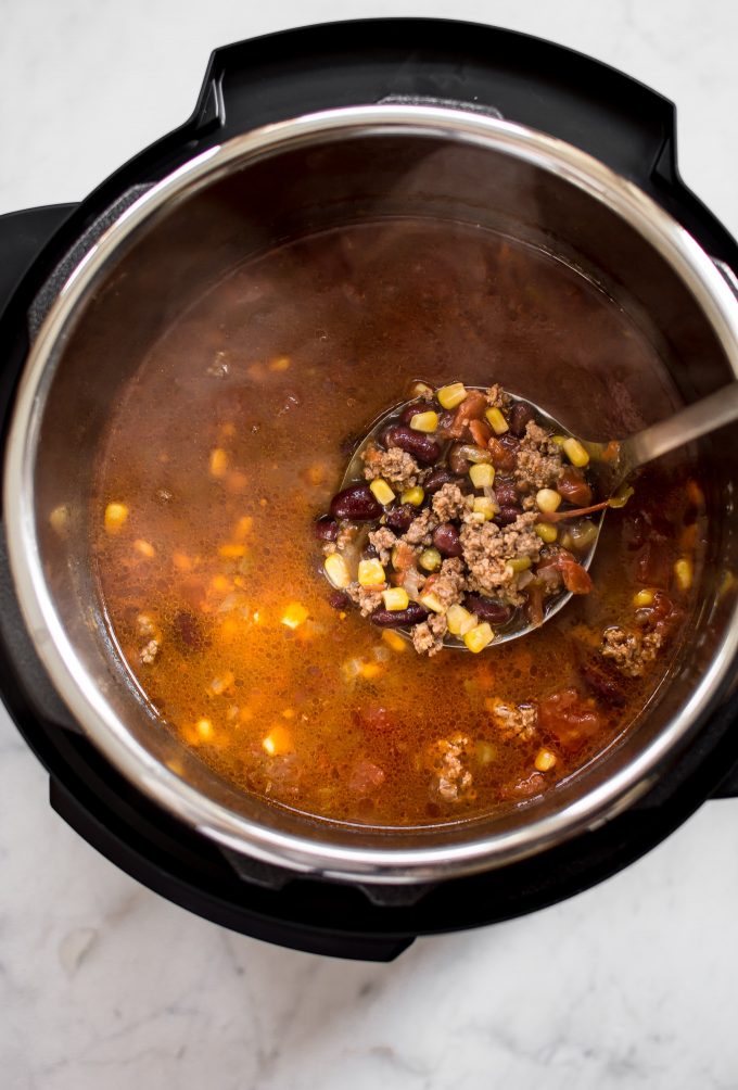 ladle spooning easy taco soup out of an Instant Pot