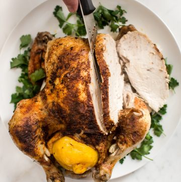 This easy Instant Pot whole chicken recipe is fast, simple, healthy, and makes the best tender chicken. This electric pressure cooker whole chicken is great for a family dinner or to have chicken meat ready for meals throughout the week! The chicken can be stuffed with lemon for extra flavor. Use the leftovers to make stock or bone broth. You can even use frozen chicken in this recipe.