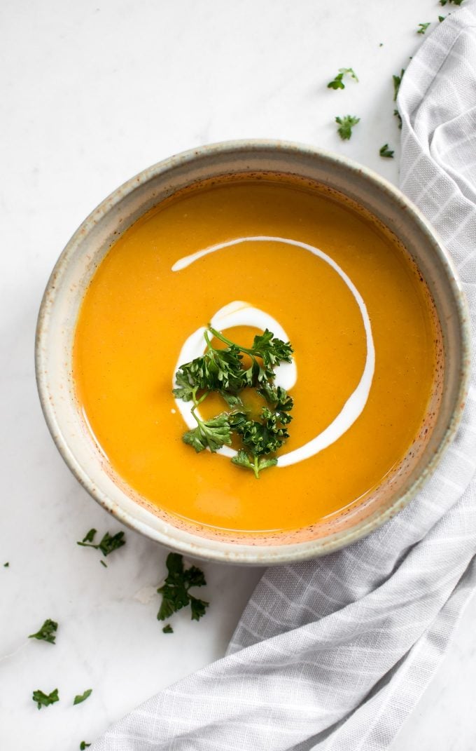 earthenware bowl with Instant Pot sweet potato soup garnished with parsley