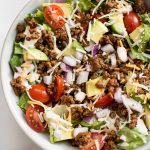 This low-carb taco salad recipe is healthy, easy to make, and it's ready in less than 30 minutes. This beef taco salad is loaded with delicious southwest flavors! A clean eating recipe that's perfect for meal prep. 