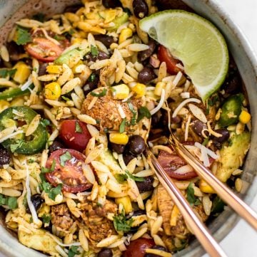 This Mexican chicken salad with orzo is fresh, healthy, and loaded with delicious Tex-Mex flavors including avocado and a delicious cilantro lime dressing! Quick and easy and ready in only 30 minutes - perfect for lunches, weeknight dinners, or potlucks.
