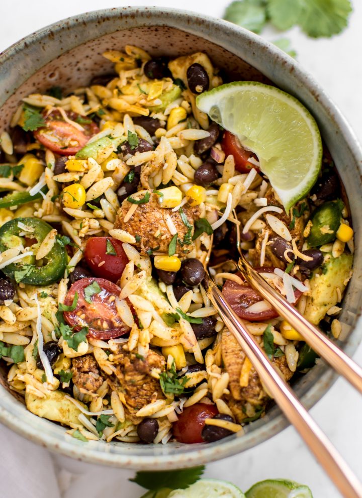 This Mexican chicken salad with orzo is fresh, healthy, and loaded with delicious Tex-Mex flavors including avocado and a delicious cilantro lime dressing! Quick and easy and ready in only 30 minutes - perfect for lunches, weeknight dinners, or potlucks.