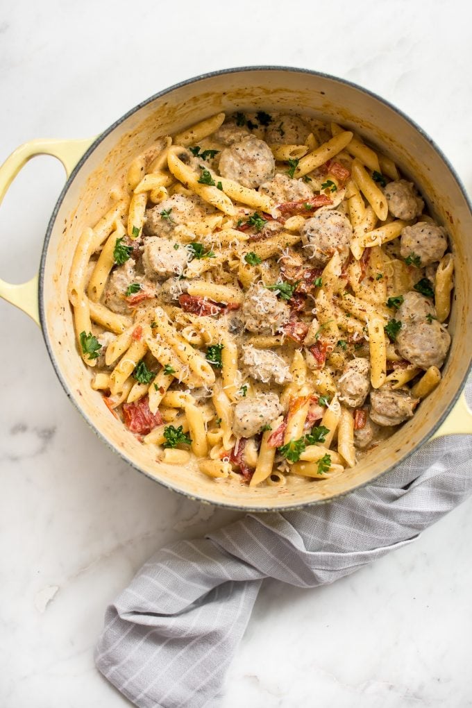 a pot of spicy Cajun pasta with a grey tea towel