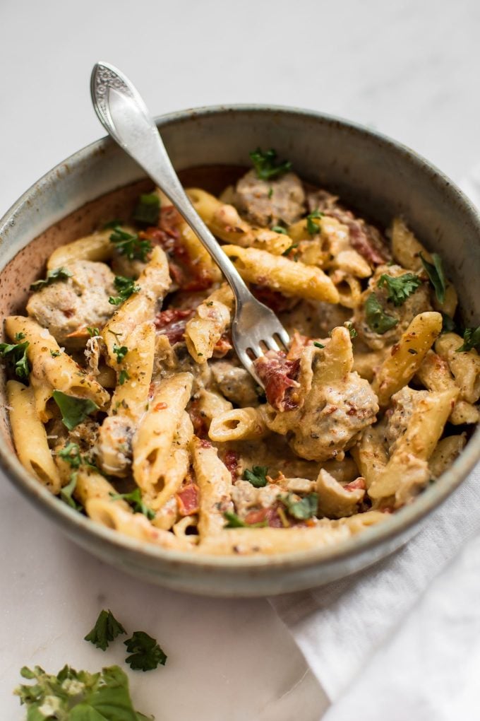 close-up of easy one-pot Cajun sausage pasta in a bowl with a fork