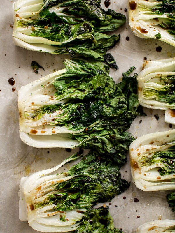 This roasted baby bok choy recipe makes a quick, easy, healthy, and delicious side dish! Garlic, lemon juice, spicy chili flakes, and soy sauce make this side dish extra tasty. Easily cooked in the oven in 10 minutes! A simple vegan recipe. 