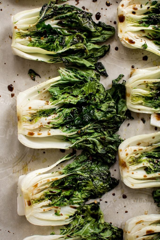 healthy roasted baby bok choy on parchment paper
