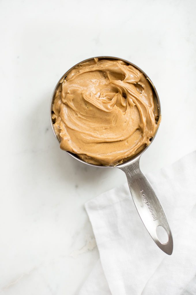 a measuring cup filled with peanut butter