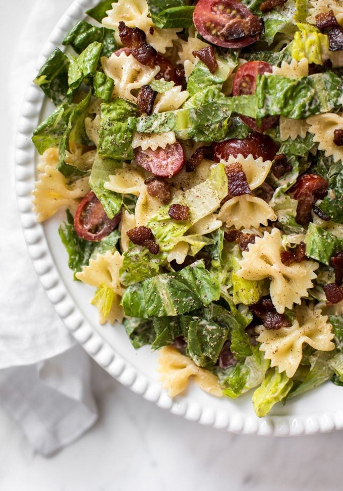 close-up of bacon, lettuce, and tomato pasta salad on a white plate