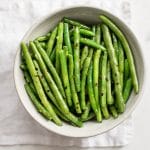 These healthy chili garlic green beans are boiled then sautéed to perfection in one pan. They couldn't be easier or more delicious! You'll love the garlic butter in this easy stove top recipe. 