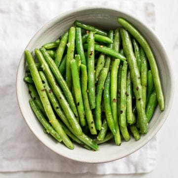 These healthy chili garlic green beans are boiled then sautéed to perfection in one pan. They couldn't be easier or more delicious! You'll love the garlic butter in this easy stove top recipe.