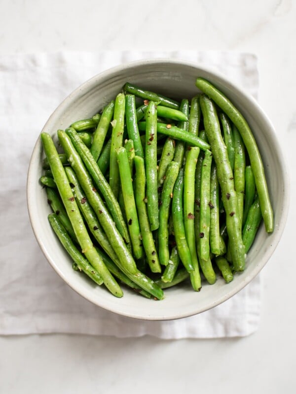 These healthy chili garlic green beans are boiled then sautéed to perfection in one pan. They couldn't be easier or more delicious! You'll love the garlic butter in this easy stove top recipe. 