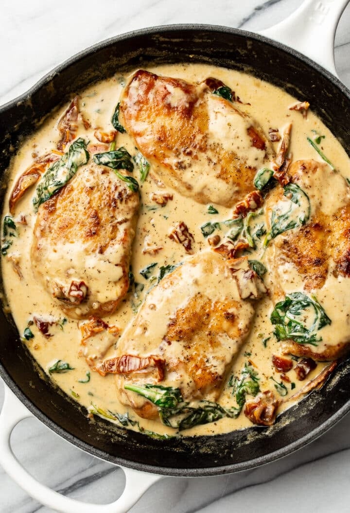 a cast iron skillet with creamy tuscan chicken