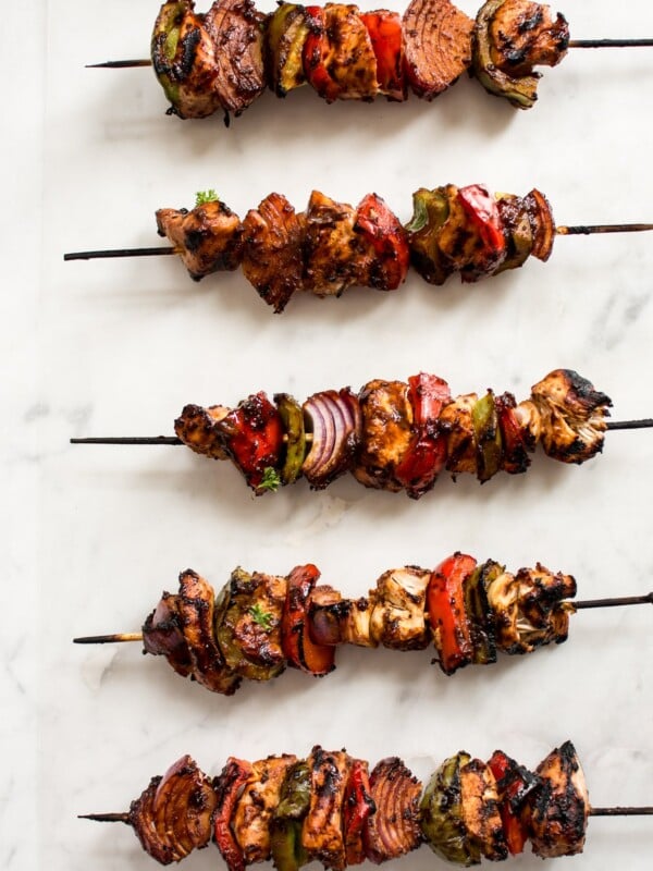 Making chicken kabobs on the grill is fast and easy! A quick marinade, red onions, green and red peppers, and some skewers is all you need to make these healthy chicken kebabs. A delicious summer BBQ recipe!