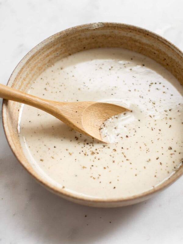 This simple vegan lemon tahini dressing is perfect on salads, roasted vegetables, and grains. It's healthy and delicious. Sweeten it with honey or maple syrup, and add as much garlic as you wish. You can thin it to your desired consistency. Quick & easy!