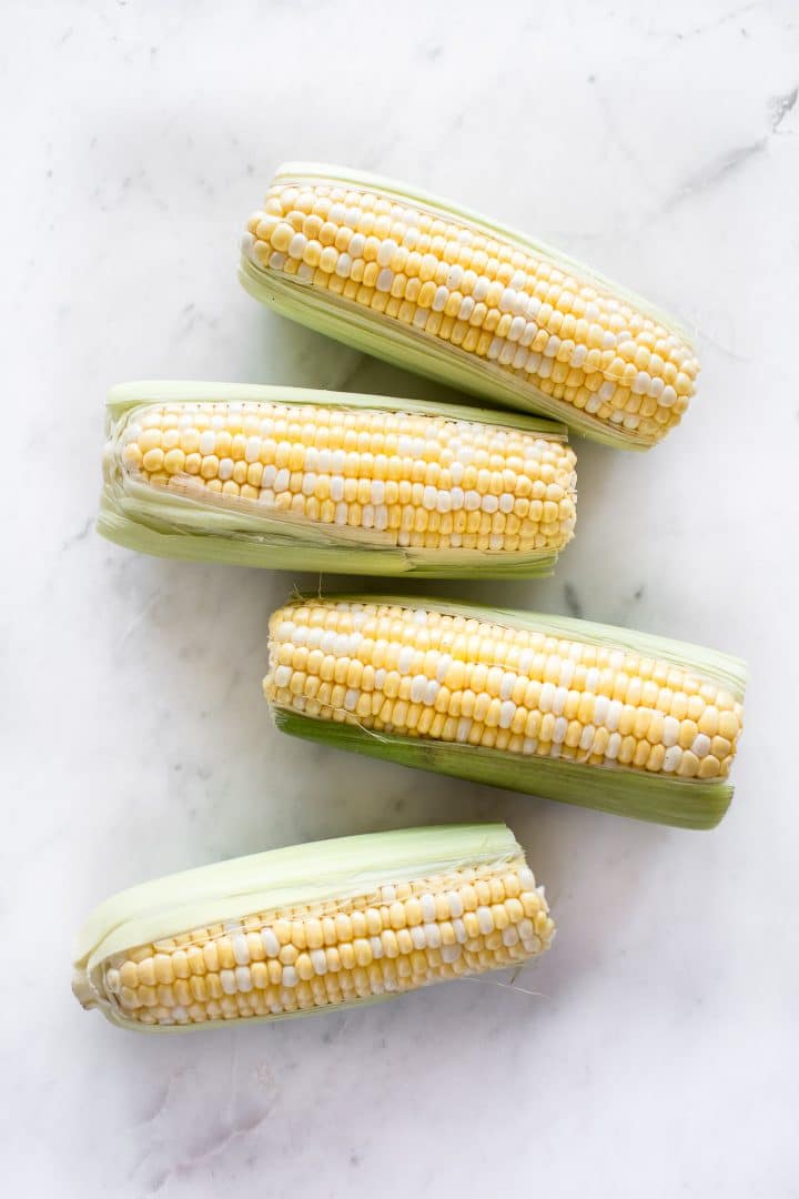 raw ears of corn a marble surface