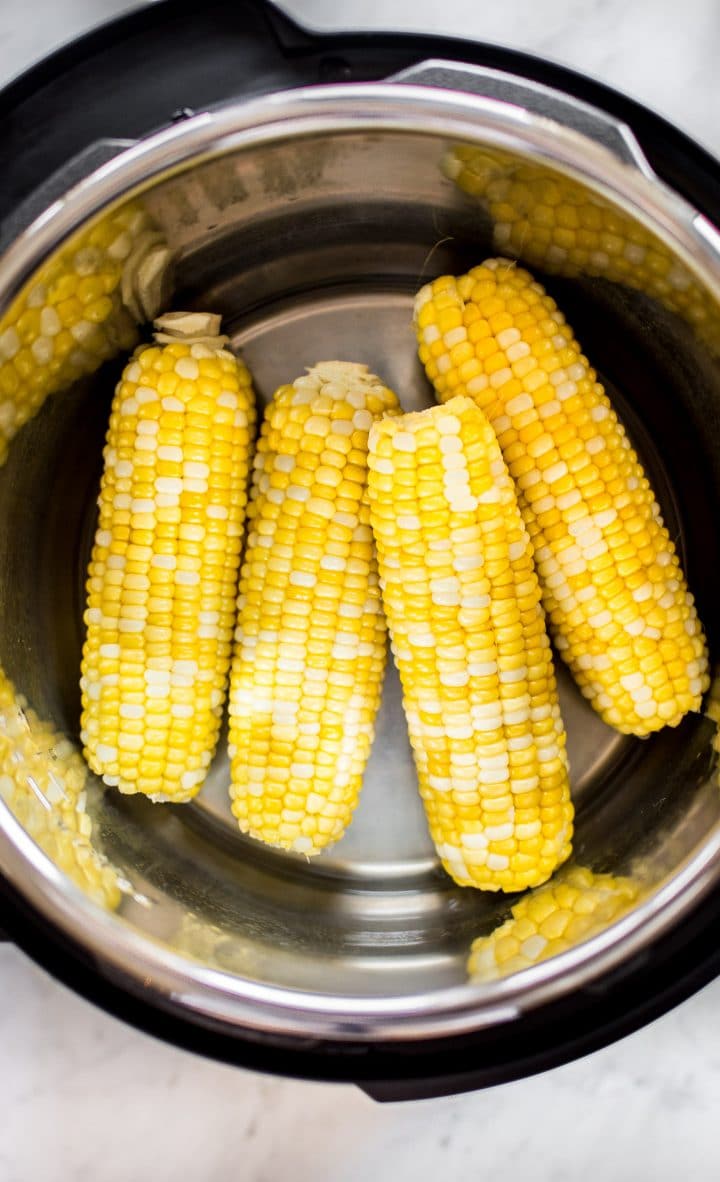 close-up of corn on the cobs inside an electric pressure cooker