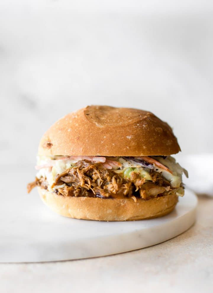 With this easy Instant Pot pulled pork recipe, you can get that slow-cooked taste - fast! This recipe uses pork shoulder, a delicious dry rub, and liquid smoke for the best tender, juicy, and fall apart pulled pork. This electric pressure cooker pulled pork makes an awesome simple family meal.