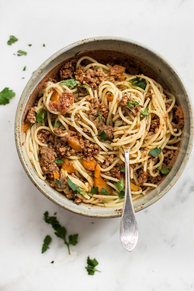 bowl of Instant Pot spaghetti and sauce with spaghetti twirled on a fork